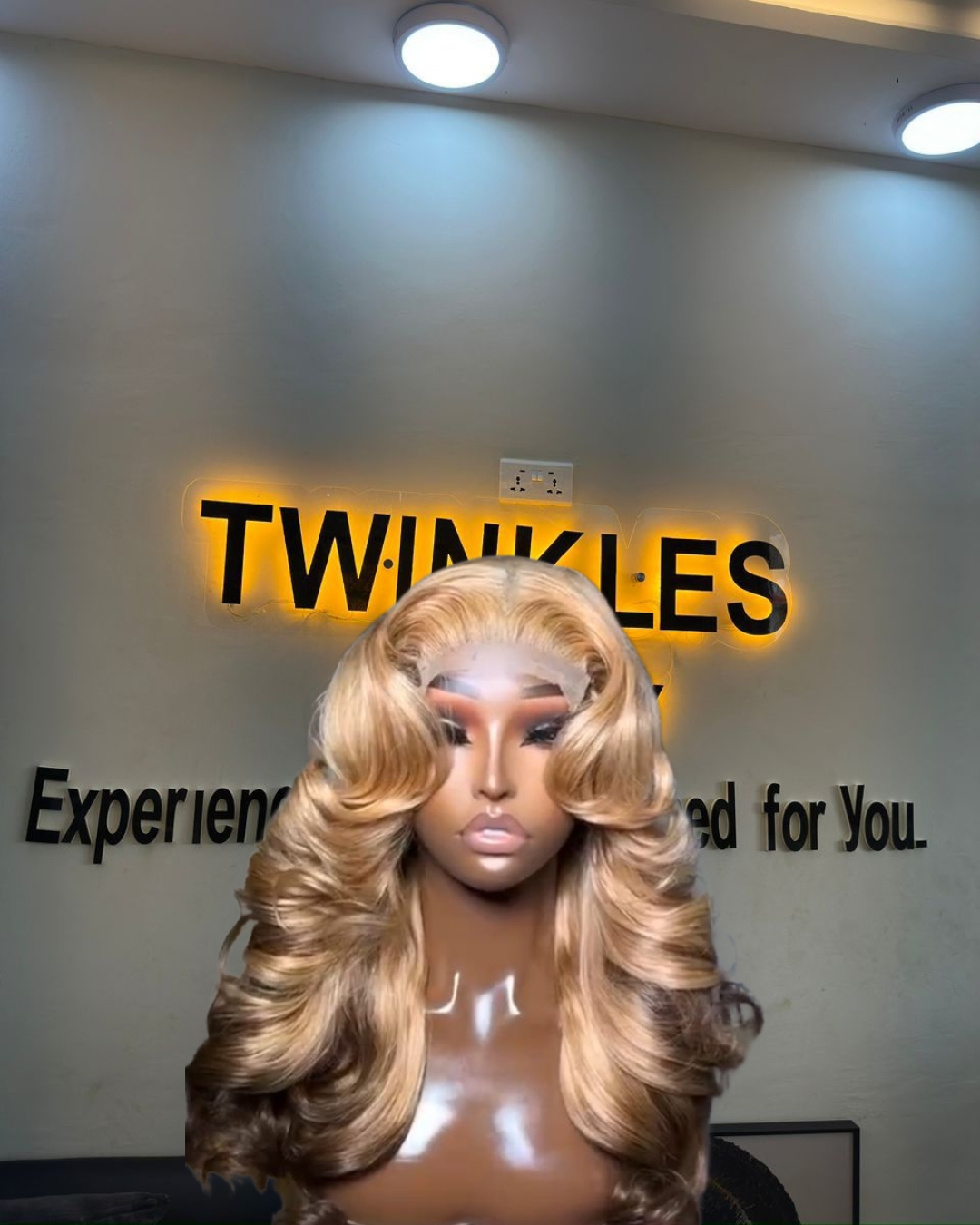 18-inch Super Double Drawn Dirty Blonde Chinese Wavy human hair wig with brown lowlights and a 5x5 Swiss lace closure.