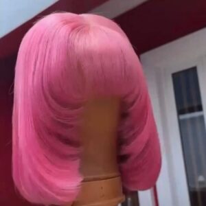 12-inch Super Double Drawn baby pink Vietnamese bone straight human hair wig styled with full fringe bangs and heavily curved, face-framing layered edges.