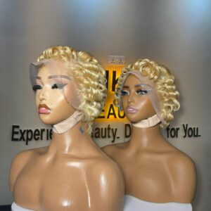 Side-by-side view of two 6-inch 613 platinum blonde short pixie curl human hair wigs styled with structured Tiwa finger waves on 13x4 Swiss lace frontals.