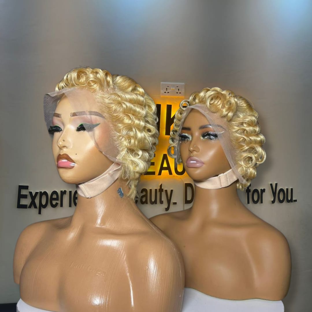 Side-by-side view of two 6-inch 613 platinum blonde short pixie curl human hair wigs styled with structured Tiwa finger waves on 13x4 Swiss lace frontals.