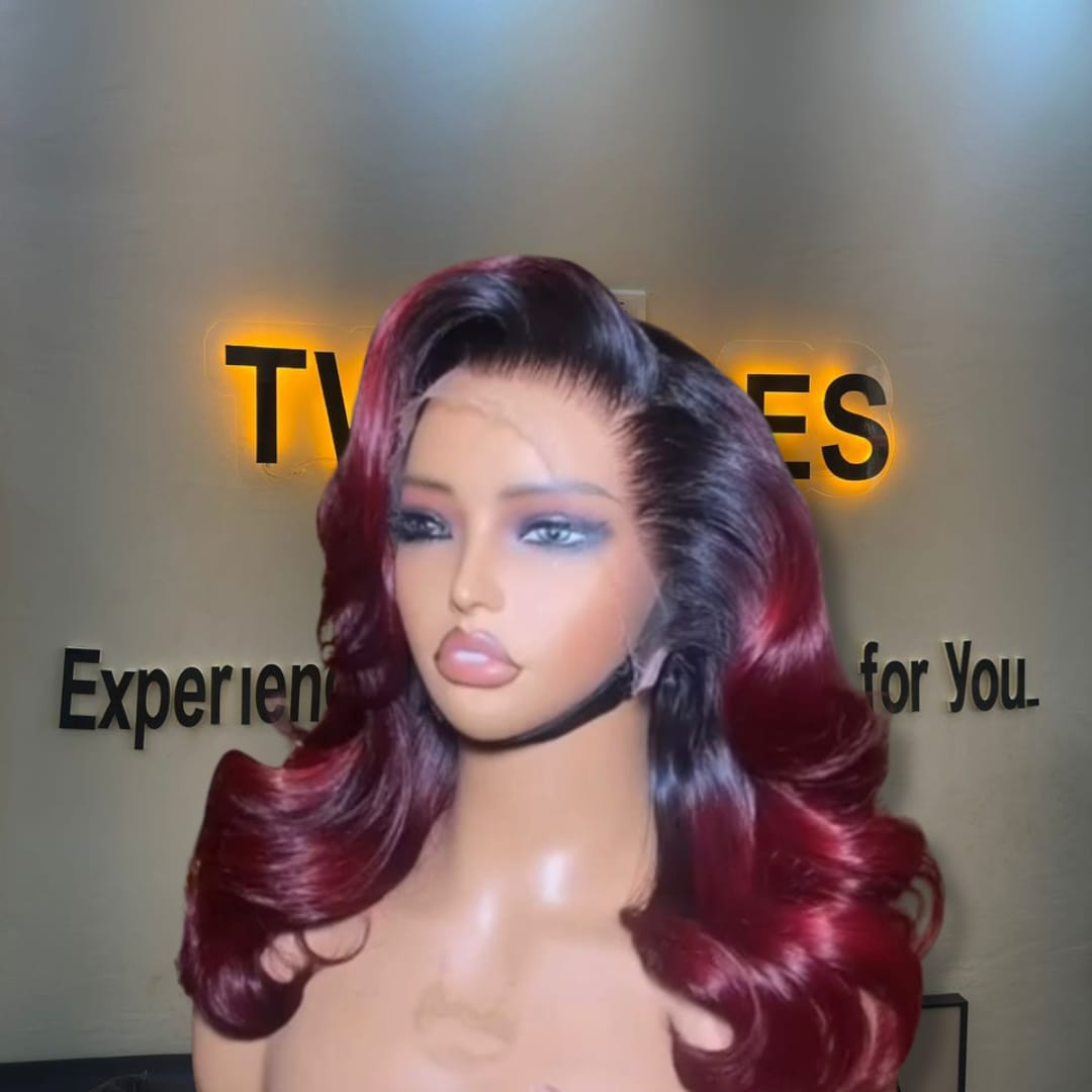 14-inch premium raw Vietnamese wavy human hair wig dyed a dark-rooted wine burgundy color, styled with voluminous layered Hollywood curls and a 5x5 closure.