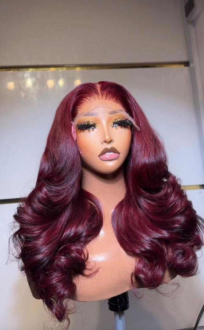 22-inch layered Burgundy 99J Vietnam Bounce human hair wig with 5x5 lace closure on a mannequin head.