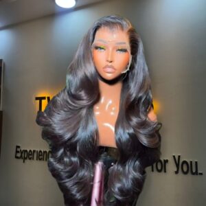 26-inch premium raw Vietnamese wavy human hair wig styled with voluminous Hollywood body waves, deep face-framing layers, and a 13x4 Swiss lace frontal.