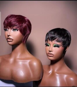Side-by-side display of two 4-inch short human hair fringe pixie crop skull cap wigs on mannequins, one in plum wine burgundy and one in sleek natural black.