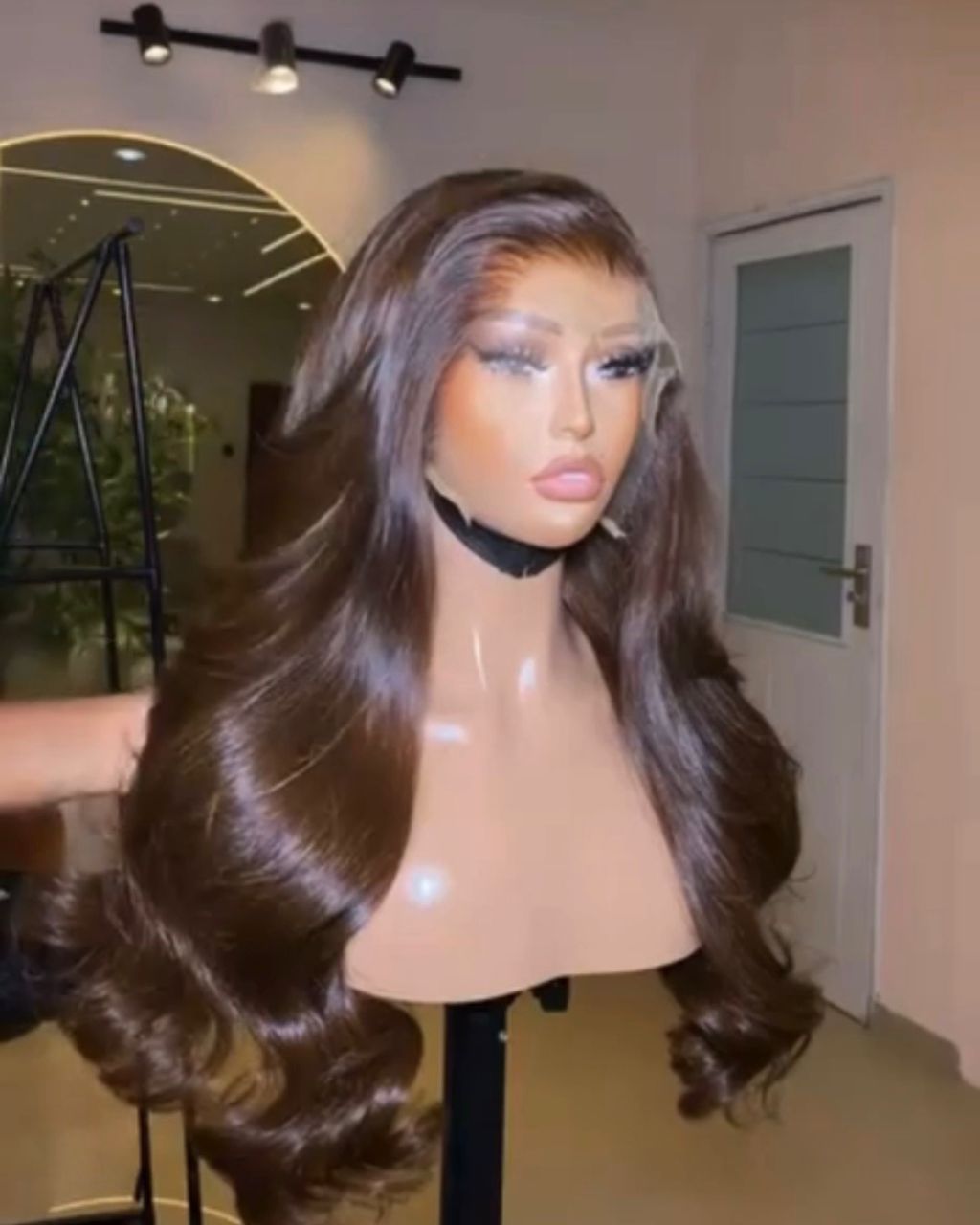 24-inch premium raw Vietnamese wavy human hair wig dyed a rich coffee brown color, styled with bouncing Hollywood layers and a 5x5 closure.